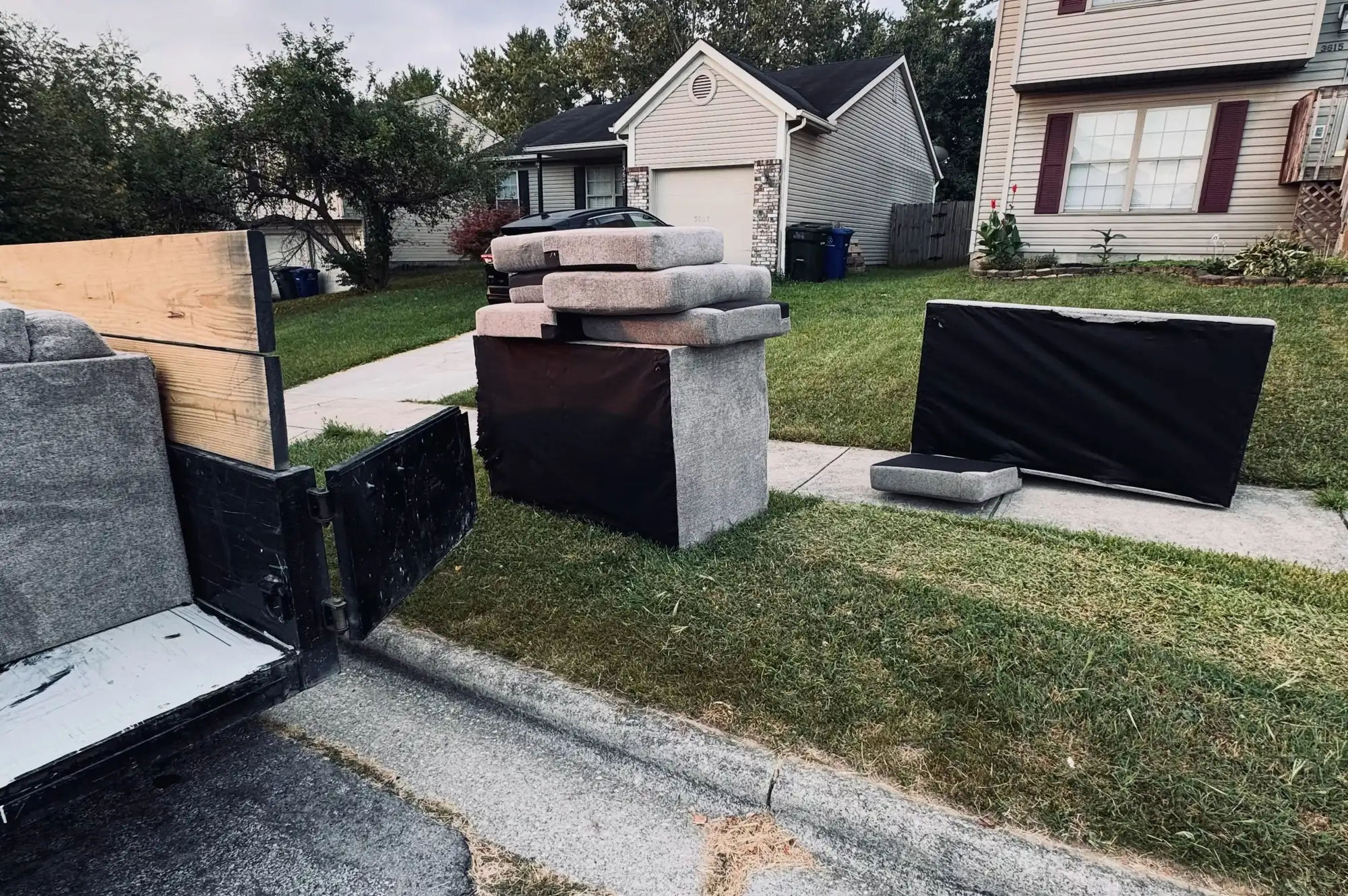 HaulRight trailer loading curbside junk on a Valrico street