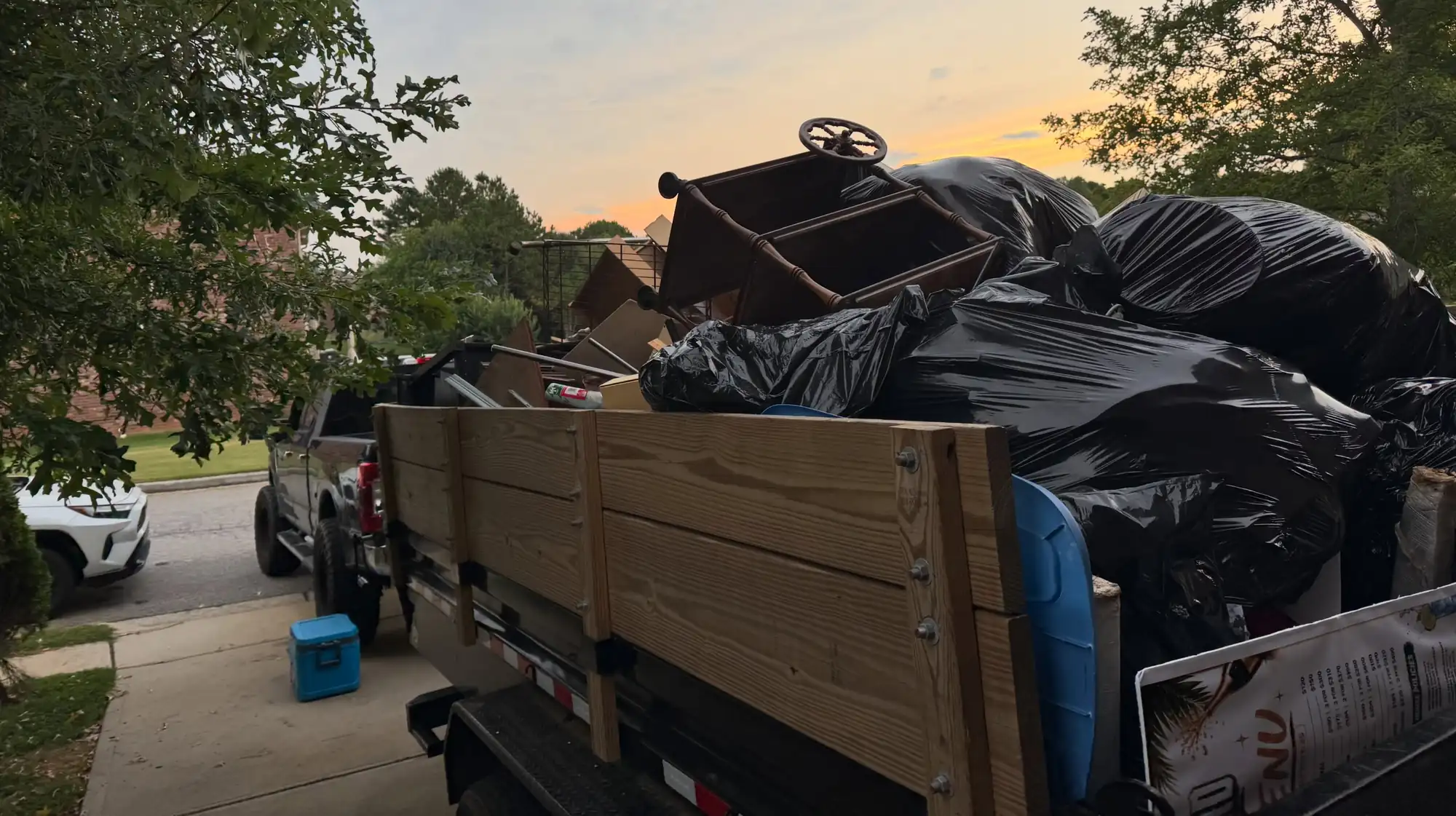 junk removal truck loaded with bags and furniture