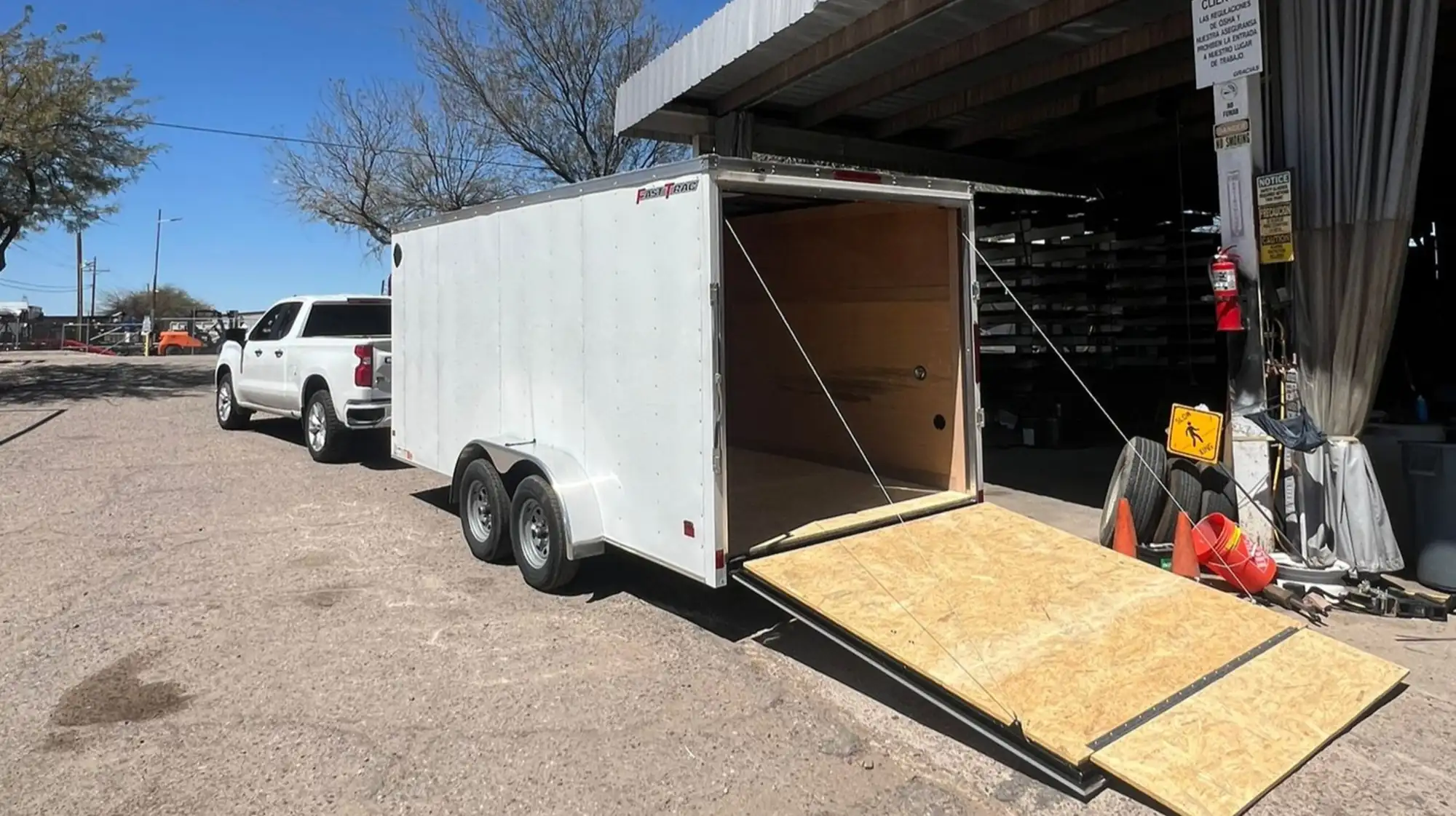 enclosed junk removal trailer at a job site