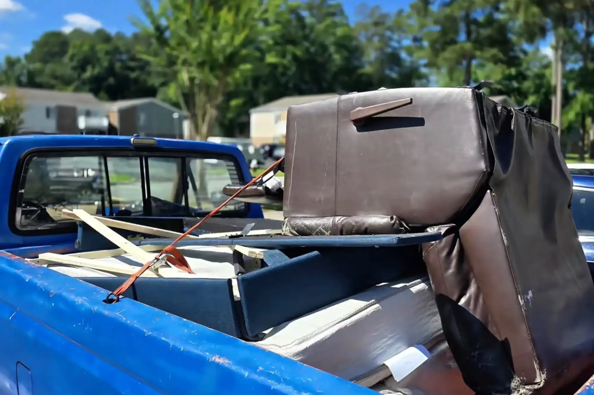 pickup truck loaded with old furniture for junk removal in Valrico