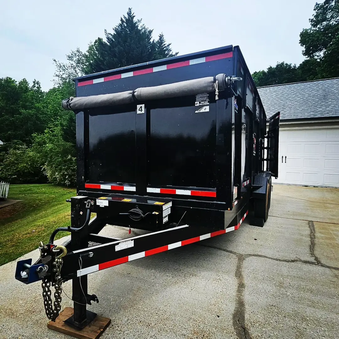 black dump trailer rental in driveway in Bloomingdale FL