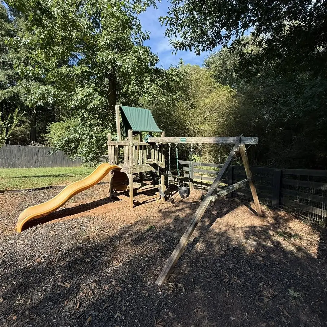 wooden playset in backyard before removal in Brandon FL